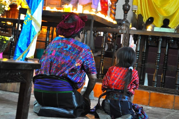 A woman and child pray in Panajachel, Guatemala